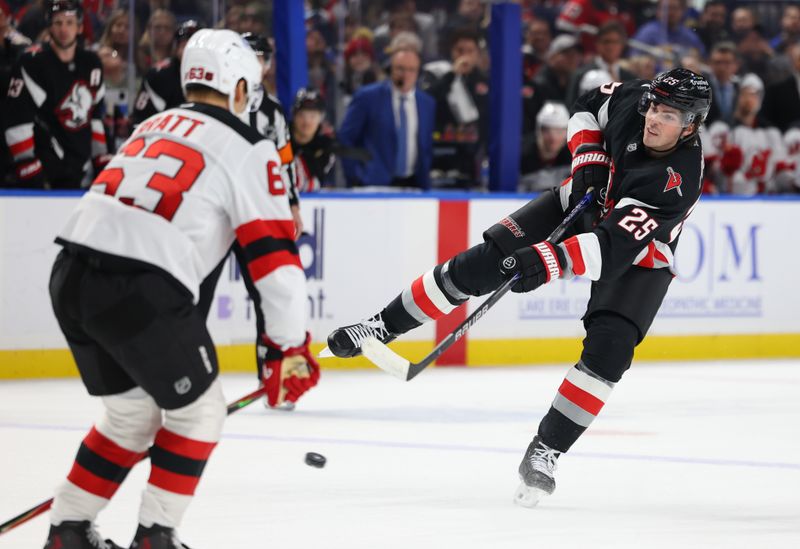 Nov 28, 2025; Buffalo, New York, USA;  Buffalo Sabres defenseman Owen Power (25) takes a shot on goal during the second period against the New Jersey Devils at KeyBank Center. Mandatory Credit: Timothy T. Ludwig-Imagn Images