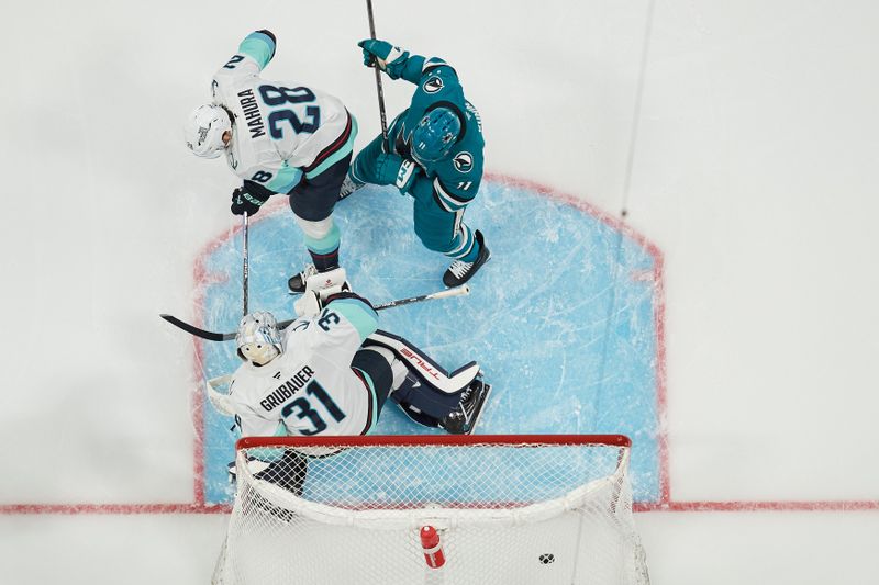 Nov 29, 2024; San Jose, California, USA; San Jose Sharks center Luke Kunin (11) reacts to a goal scored against Seattle Kraken goaltender Philipp Grubauer (31) and defenseman Joshua Mahura (28) during the first period at SAP Center at San Jose. Mandatory Credit: Robert Edwards-Imagn Images