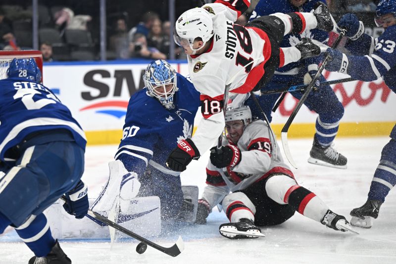 Feb 28, 2026; Toronto, Ontario, CAN;  Ottawa Senators forward Tim Stutzle (18) flies over forward Drake Batherson (19) pursing a rebound after a save by Toronto Maple Leafs goalie Joseph Woll (60) in the second period at Scotiabank Arena. Mandatory Credit: Dan Hamilton-Imagn Images