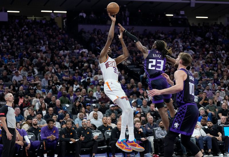 SACRAMENTO, CALIFORNIA - APRIL 12: Kevin Durant #35 of the Phoenix Suns shoots over Keon Ellis #23 of the Sacramento Kings during the first half of an NBA basketball game at Golden 1 Center on April 12, 2024 in Sacramento, California. NOTE TO USER: User expressly acknowledges and agrees that, by downloading and or using this photograph, User is consenting to the terms and conditions of the Getty Images License Agreement. (Photo by Thearon W. Henderson/Getty Images)