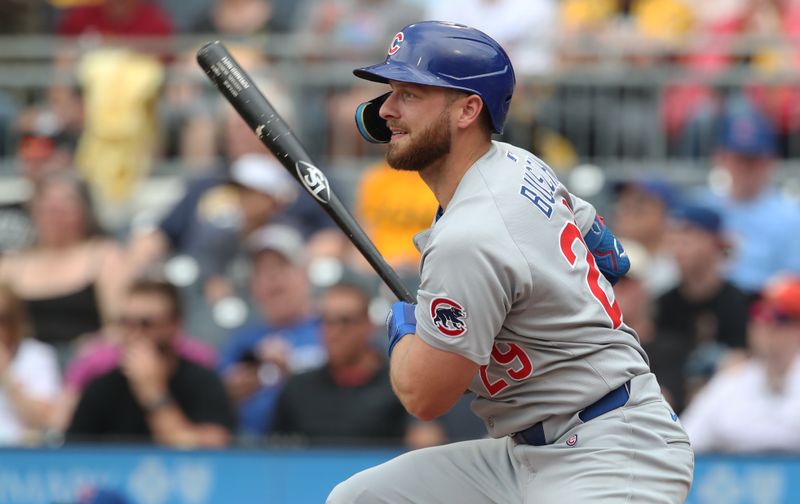 May 1, 2025; Pittsburgh, Pennsylvania, USA;  Chicago Cubs first baseman Michael Busch (29) hits a single against the Pittsburgh Pirates during the fifth inning at PNC Park. Mandatory Credit: Charles LeClaire-Imagn Images