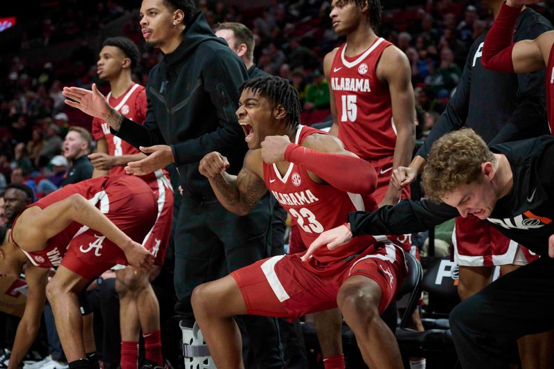 Nov 24, 2022; Portland, Oregon, USA; Alabama Crimson Tide forward Nick Pringle (23) celebrates a three point score with teammates during the second half against the Michigan State Spartans at Moda Center. Alabama won the game 81-70. Mandatory Credit: Troy Wayrynen-USA TODAY Sports