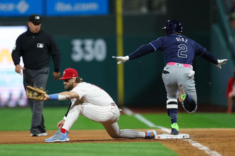 Sep 9, 2024; Philadelphia, Pennsylvania, USA; Tampa Bay Rays first base Yandy Díaz (2) beats out the throw to Philadelphia Phillies first base Bryce Harper (3) for a single during the eighth inning at Citizens Bank Park. Mandatory Credit: Bill Streicher-Imagn Images
