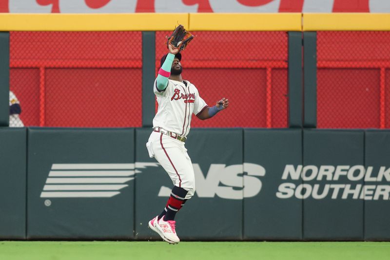 Sep 3, 2024; Atlanta, Georgia, USA; Atlanta Braves center fielder Michael Harris II (23) catches a fly ball against the Colorado Rockies in the seventh inning at Truist Park. Mandatory Credit: Brett Davis-Imagn Images 
