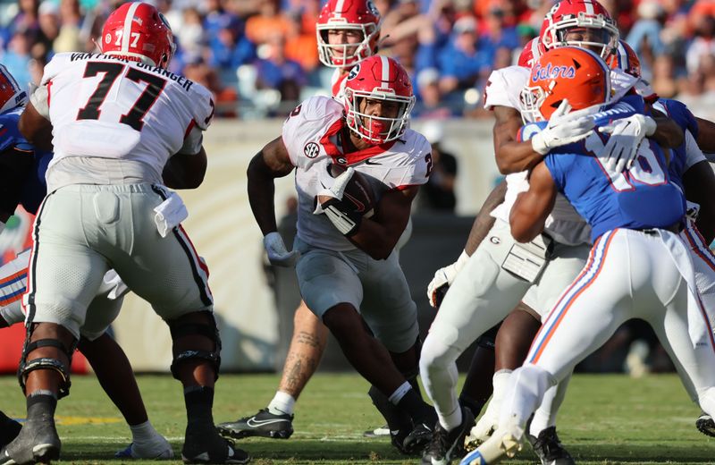 Oct 28, 2023; Jacksonville, Florida, USA; Georgia Bulldogs running back Kendall Milton (2) runs with the ball against the Florida Gators during the first half at EverBank Stadium. Mandatory Credit: Kim Klement Neitzel-USA TODAY Sports