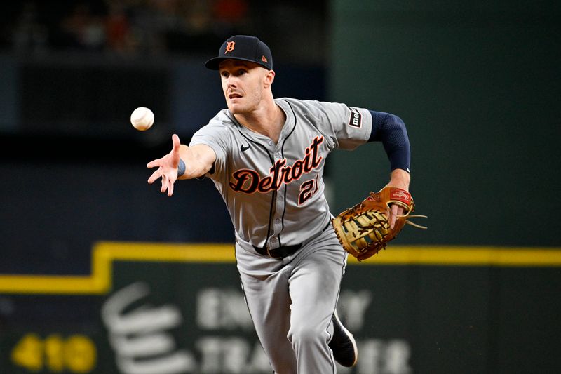 Jun 3, 2024; Arlington, Texas, USA; Detroit Tigers first baseman Mark Canha (21) tosses the ball to first base for an out during the first inning against the Texas Rangers at Globe Life Field. Mandatory Credit: Jerome Miron-USA TODAY Sports