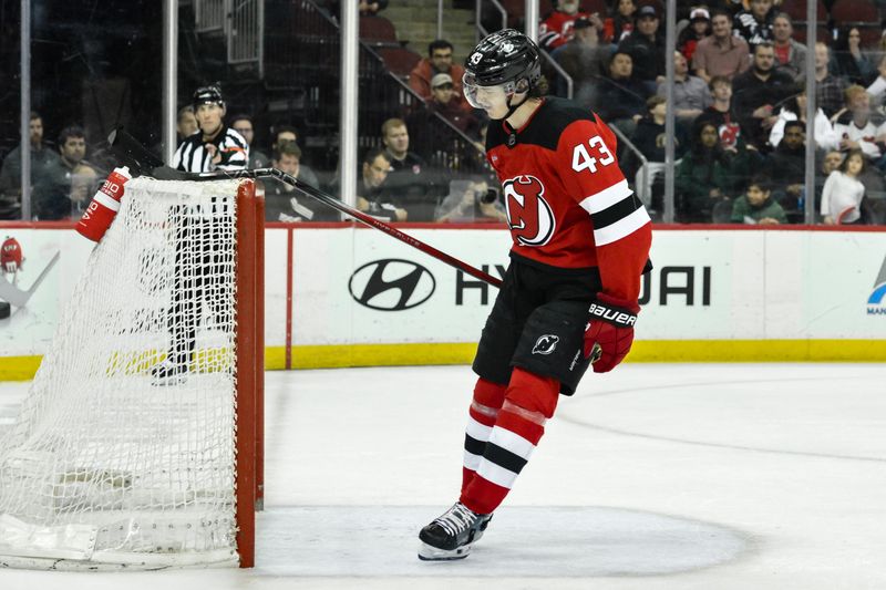 Apr 2, 2024; Newark, New Jersey, USA; New Jersey Devils defenseman Luke Hughes (43) reacts after an empty net goal by Pittsburgh Penguins center Sidney Crosby (87) during the third period at Prudential Center. Mandatory Credit: John Jones-USA TODAY Sports