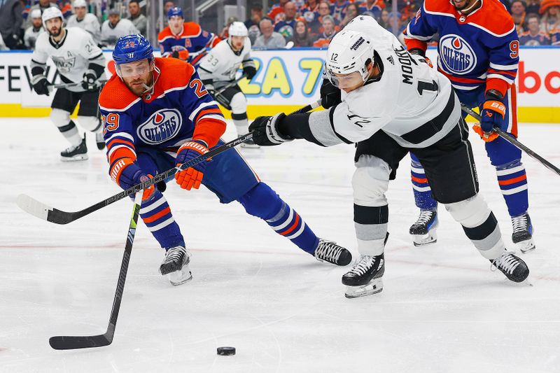 May 1, 2024; Edmonton, Alberta, CAN; Edmonton Oilers forward Leon Draisaitl (29) and Los Angeles Kings forward Trevor Moore (12) battle for a loose puck  during the first period in game five of the first round of the 2024 Stanley Cup Playoffs at Rogers Place. Mandatory Credit: Perry Nelson-USA TODAY Sports