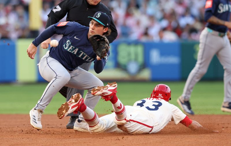 Jun 6, 2025; Anaheim, California, USA; Los Angeles Angels outfielder Chris Taylor (33) steals second against Seattle Mariners second baseman Cole Young (2) during the third inning at Angel Stadium. Mandatory Credit: Jason Parkhurst-Imagn Images