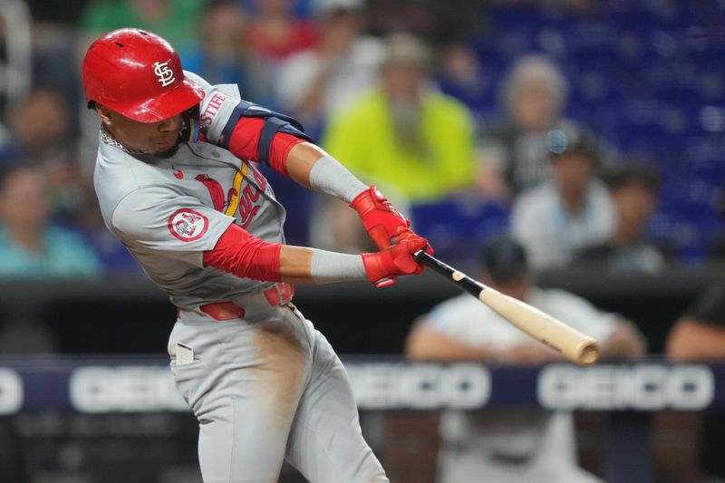 Jun 17, 2024; Miami, Florida, USA;  St. Louis Cardinals shortstop Masyn Winn (0) hits a two-run home run in the 12th inning against the Miami Marlins at loanDepot Park. Mandatory Credit: Jim Rassol-USA TODAY Sports