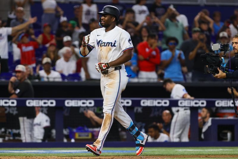 Jul 4, 2024; Miami, Florida, USA; Miami Marlins right fielder Jesus Sanchez (12) reacts on his way to home plate after hitting a two-run home run against the Boston Red Sox during the eleventh inning at loanDepot Park. Mandatory Credit: Sam Navarro-USA TODAY Sports