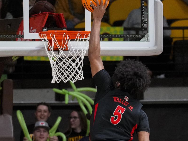 Feb 27, 2024; Laramie, Wyoming, USA; UNLV Runnin' Rebels guard Rob Whaley Jr. (5) dunks against Wyoming Cowboys forward Cam Manyawu (5) during overtime at Arena-Auditorium. Mandatory Credit: Troy Babbitt-USA TODAY Sports