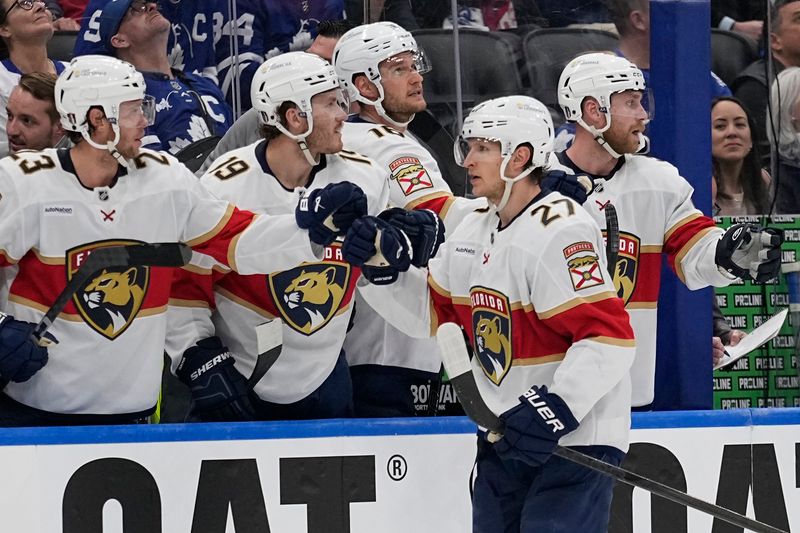 May 5, 2025; Toronto, Ontario, CAN; Florida Panthers forward Eetu Luostarinen (27) is congratulated after scoring against the Toronto Maple Leafs during the third period of the second round of the 2025 Stanley Cup Playoffs at Scotiabank Arena. Mandatory Credit: John E. Sokolowski-Imagn Images