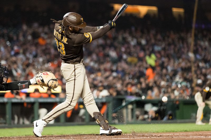 Sep 27, 2023; San Francisco, California, USA; San Diego Padres right fielder Fernando Tatis Jr. (23) grounds a single against the San Francisco Giants during the third inning at Oracle Park. Mandatory Credit: John Hefti-USA TODAY Sports