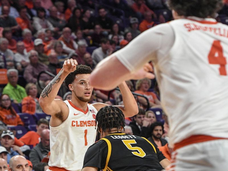 Feb 27, 2024; Clemson, South Carolina, USA; Clemson senior guard Chase Hunter (1) passes to  forward Ian Schieffelin (4) near Pitt guard Ishmael Leggett (5)during the first half at Littlejohn Coliseum. Mandatory Credit: Ken Ruinard-USA TODAY Sports