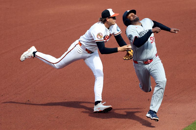 Mar 29, 2026; Baltimore, Maryland, USA; Baltimore Orioles first baseman Coby Mayo (16) tags Minnesota Twins first baseman Josh Bell (56) out during the fourth inning at Oriole Park at Camden Yards. Mandatory Credit: Daniel Kucin Jr.-Imagn Images