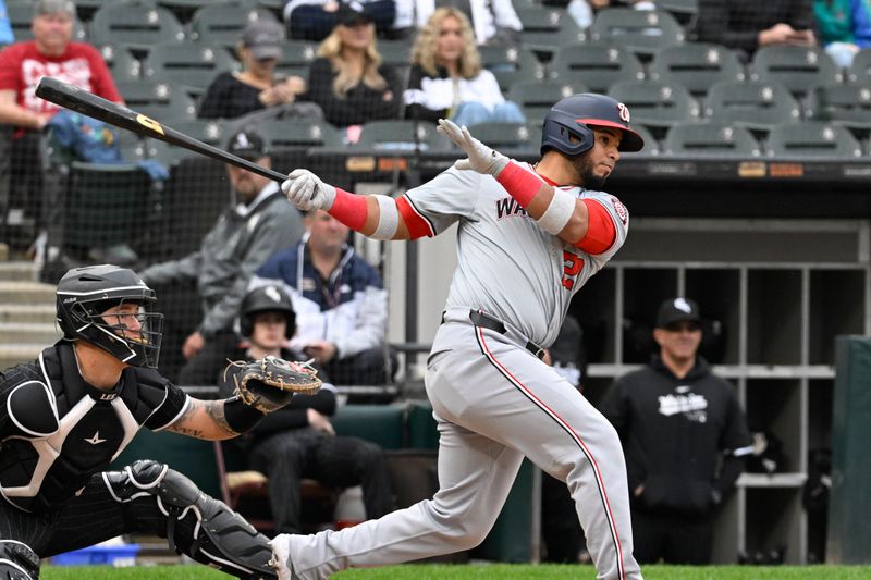 May 14, 2024; Chicago, Illinois, USA; Washington Nationals catcher Keibert Ruiz (20) hits an RBI single against the Chicago White Sox during the eighth inning at Guaranteed Rate Field. Mandatory Credit: Matt Marton-USA TODAY Sports