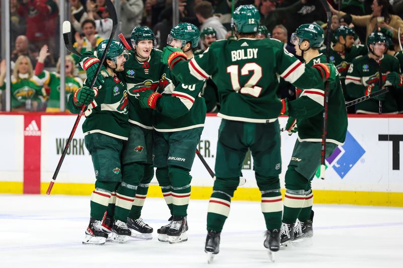 Apr 3, 2023; Saint Paul, Minnesota, USA; Minnesota Wild defenseman John Klingberg (3) celebrates his goal with teammates during the second period against the Vegas Golden Knights  at Xcel Energy Center. Mandatory Credit: Matt Krohn-USA TODAY Sports