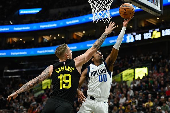 SALT LAKE CITY, UTAH - JANUARY 01: Brandon Williams #00 of the Dallas Mavericks shoots over Luka Samanic #19 of the Utah Jazz during the second half of a game at Delta Center on January 01, 2024 in Salt Lake City, Utah. NOTE TO USER: User expressly acknowledges and agrees that, by downloading and or using this photograph, User is consenting to the terms and conditions of the Getty Images License Agreement. (Photo by Alex Goodlett/Getty Images)