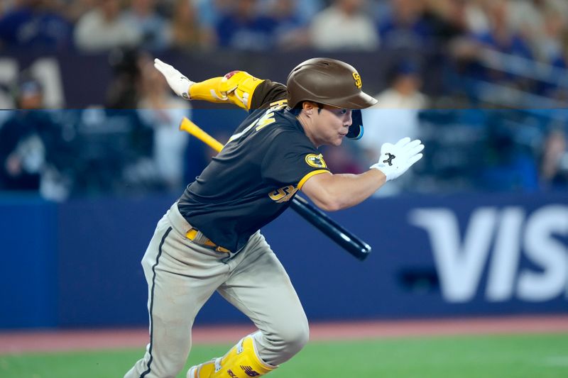 Jul 19, 2023; Toronto, Ontario, CAN; San Diego Padres second baseman Ha-Seong Kim (7) runs to first base on a single against the Toronto Blue Jays during the ninth inning at Rogers Centre. Mandatory Credit: John E. Sokolowski-USA TODAY Sports