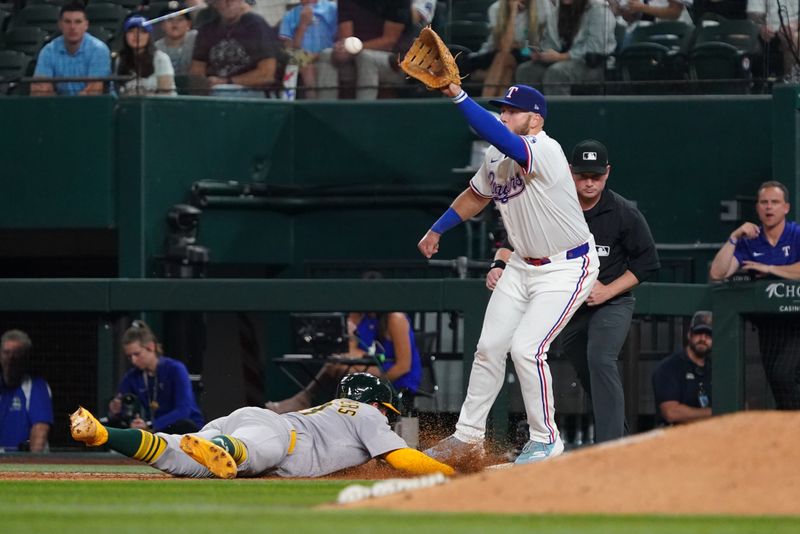 Apr 28, 2025; Arlington, Texas, USA; Athletics catcher Shea Langeliers (23) is doubled up at first base as Texas Rangers first baseman Jake Burger (21) reaches for the ball during the eighth inning at Globe Life Field. Mandatory Credit: Raymond Carlin III-Imagn Images