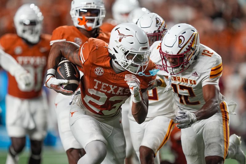 Sep 21, 2024; Austin, Texas, USA;  Texas Longhorns running back Jaydon Blue (23) runs in front of Louisiana Monroe Warhawks defensive back Wydett Williams Jr. (12) in the second half at Darrell K Royal-Texas Memorial Stadium. Mandatory Credit: Daniel Dunn-Imagn Images