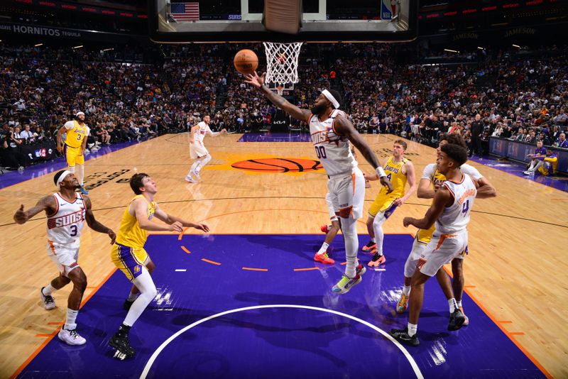 PHOENIX, AZ - OCTOBER 17: Royce O'Neale #00 of the Phoenix Suns goes up for the rebound during the game against the Los Angeles Lakers during a NBA Preseason game on October 17, 2024 at Footprint Center in Phoenix, Arizona. NOTE TO USER: User expressly acknowledges and agrees that, by downloading and or using this photograph, user is consenting to the terms and conditions of the Getty Images License Agreement. Mandatory Copyright Notice: Copyright 2024 NBAE (Photo by Barry Gossage/NBAE via Getty Images)