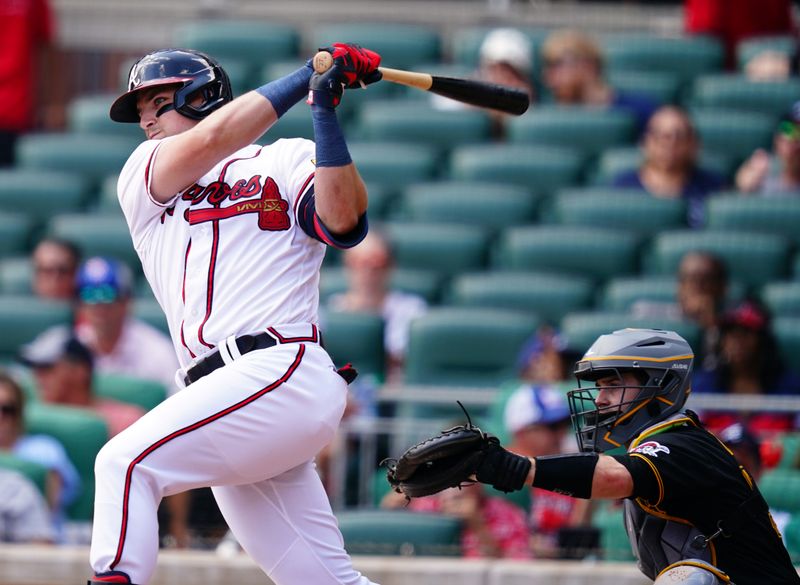 Sep 10, 2023; Cumberland, Georgia, USA; Atlanta Braves third baseman Austin Riley (27) hits a single against the Pittsburgh Pirates during the sixth inning at Truist Park. Mandatory Credit: John David Mercer-USA TODAY Sports