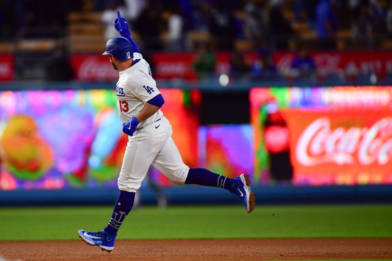 May 4, 2024; Los Angeles, California, USA; Los Angeles Dodgers third baseman Max Muncy (13) runs the bases after hitting a solo home run against the Atlanta Braves during the eighth inning at Dodger Stadium. Mandatory Credit: Gary A. Vasquez-USA TODAY Sports