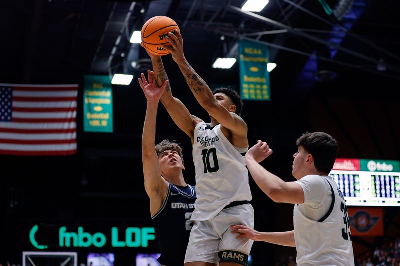 Mar 1, 2025; Fort Collins, Colorado, USA; Colorado State Rams guard Nique Clifford (10) grabs a rebound against Utah State Aggies forward Tucker Anderson (2) as forward Kyle Jorgensen (35) defends in the second half at Moby Arena. Mandatory Credit: Isaiah J. Downing-Imagn Images