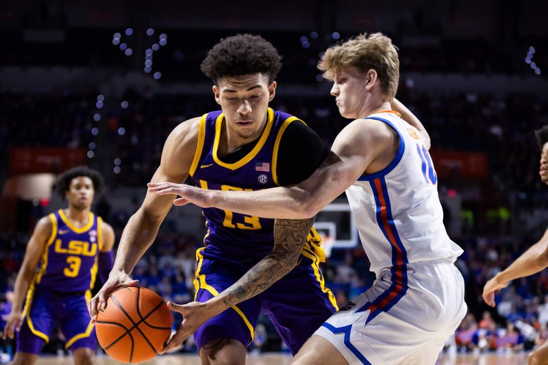 Feb 13, 2024; Gainesville, Florida, USA; Florida Gators forward Thomas Haugh (10) defends LSU Tigers forward Jalen Reed (13) during the first half at Exactech Arena at the Stephen C. O'Connell Center. Mandatory Credit: Matt Pendleton-USA TODAY Sports