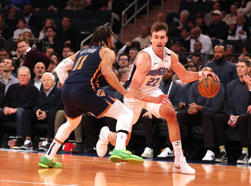 NEW YORK, NEW YORK - DECEMBER 03:   Franz Wagner #22 of the Orlando Magic drives against Jalen Brunson #11 of the New York Knicks during their game at Madison Square Garden on December 03, 2024 in New York City.   User expressly acknowledges and agrees that, by downloading and or using this photograph, User is consenting to the terms and conditions of the Getty Images License Agreement.  (Photo by Al Bello/Getty Images)