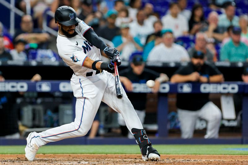 Jun 4, 2023; Miami, Florida, USA; Miami Marlins left fielder Bryan De La Cruz (14) hits a single against the Oakland Athletics during the fifth inning at loanDepot Park. Mandatory Credit: Sam Navarro-USA TODAY Sports