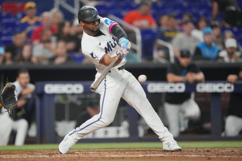 May 21, 2024; Miami, Florida, USA; Miami Marlins second baseman Otto Lopez (61) hits a single that drove in run in the second inning against the Milwaukee Brewers at loanDepot Park. Mandatory Credit: Jim Rassol-USA TODAY Sports