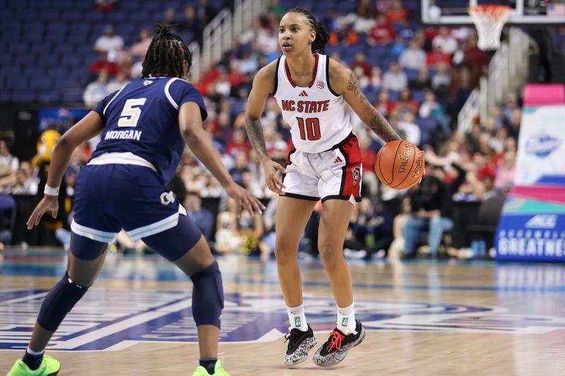 Mar 7, 2025; Greensboro, NC, USA;  NC State Wolfpack guard Aziaha James (10) sets the play against Georgia Tech Yellow Jackets guard Tonie Morgan (5) during the third quarter at First Horizon Coliseum. Mandatory Credit: Cory Knowlton-Imagn Images