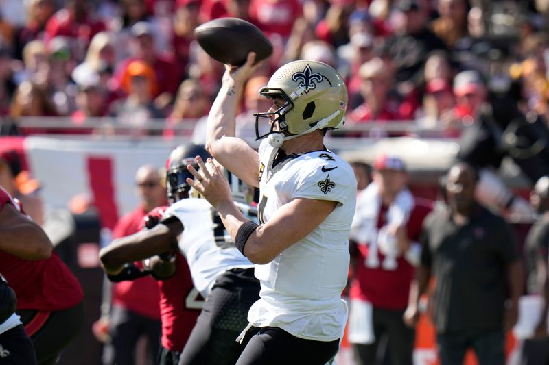 New Orleans Saints quarterback Derek Carr (4) passes in the first half of an NFL football game against the Tampa Bay Buccaneers in Tampa, Fla., Sunday, Dec. 31, 2023. (AP Photo/Chris O'Meara)