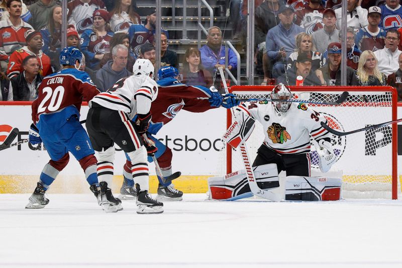 Oct 19, 2023; Denver, Colorado, USA; Colorado Avalanche left wing Tomas Tatar (90) attempts to bat the puck out of the air against Chicago Blackhawks goaltender Petr Mrazek (34) as center Ryan Donato (8) and center Ross Colton (20) defend in the first period at Ball Arena. Mandatory Credit: Isaiah J. Downing-USA TODAY Sports
