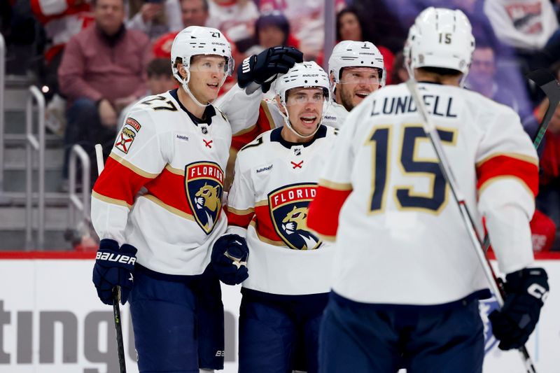 Mar 2, 2024; Detroit, Michigan, USA; Florida Panthers center Evan Rodrigues (17) celebrates with teammates after scoring in the third period against the Detroit Red Wings at Little Caesars Arena. Mandatory Credit: Rick Osentoski-USA TODAY Sports