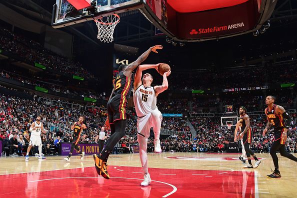 ATLANTA, GA - DECEMBER 11: Nikola Jokic #15 of the Denver Nuggets shoots the ball during the game against the Atlanta Hawks on December 11, 2023 at State Farm Arena in Atlanta, Georgia.  NOTE TO USER: User expressly acknowledges and agrees that, by downloading and/or using this Photograph, user is consenting to the terms and conditions of the Getty Images License Agreement. Mandatory Copyright Notice: Copyright 2023 NBAE (Photo by Scott Cunningham/NBAE via Getty Images)