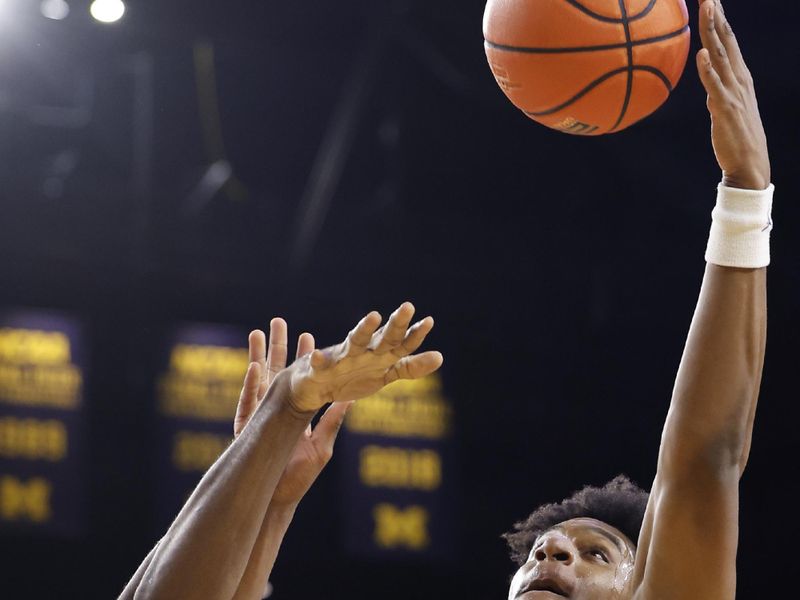 Feb 3, 2024; Ann Arbor, Michigan, USA;  Michigan Wolverines forward Tarris Reed Jr. (32) grabs the rebound over Rutgers Scarlet Knights center Emmanuel Ogbole (22) in the first half at Crisler Center. Mandatory Credit: Rick Osentoski-USA TODAY Sports