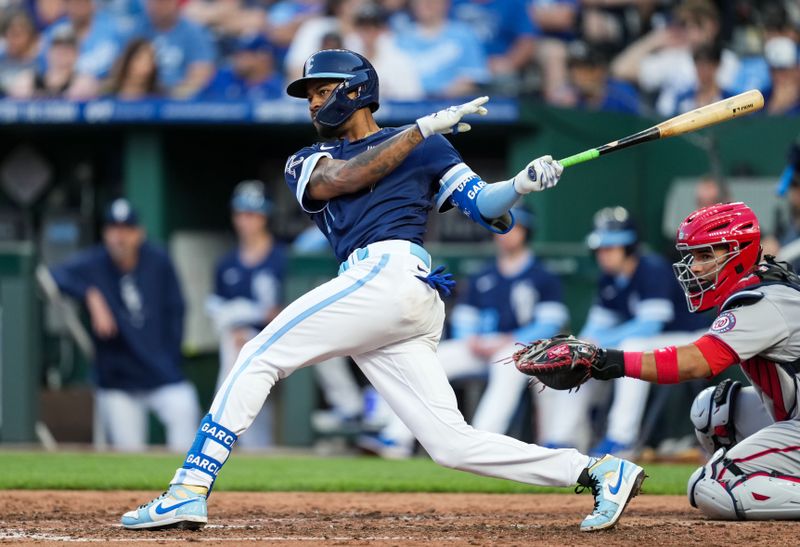 May 26, 2023; Kansas City, Missouri, USA; Kansas City Royals third baseman Maikel Garcia (11) hits an RBI double during the fourth inning against the Kansas City Royals at Kauffman Stadium. Mandatory Credit: Jay Biggerstaff-USA TODAY Sports