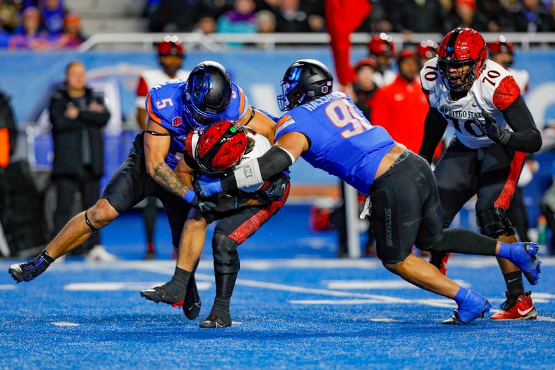 Nov 1, 2024; Boise, Idaho, USA; Boise State Broncos defensive end Ahmed Hassanein (91) and defensive end Jayden Virgin-Morgan (5) sack San Diego State Aztecs quarterback Danny O'Neil (5) during the second half at Albertsons Stadium. Boise State defeats San Diego State  56-24. Mandatory Credit: Brian Losness-Imagn Images

