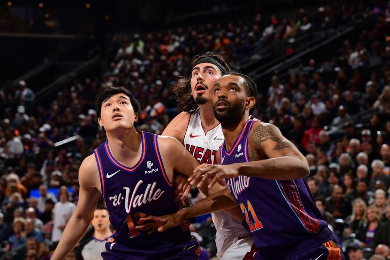 PHOENIX, AZ - JANUARY  5:  Yuta Watanabe #18 and Keita Bates-Diop #21 of the Phoenix Suns box out Jaime Jaquez Jr. #11 of the Miami Heat during the game on January 5, 2023 at Footprint Center in Phoenix, Arizona. NOTE TO USER: User expressly acknowledges and agrees that, by downloading and or using this photograph, user is consenting to the terms and conditions of the Getty Images License Agreement. Mandatory Copyright Notice: Copyright 2024 NBAE (Photo by Kate Frese/NBAE via Getty Images)