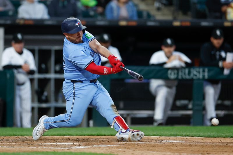 May 27, 2024; Chicago, Illinois, USA; Toronto Blue Jays catcher Alejandro Kirk (30) singles against the Chicago White Sox during the sixth inning at Guaranteed Rate Field. Mandatory Credit: Kamil Krzaczynski-USA TODAY Sports