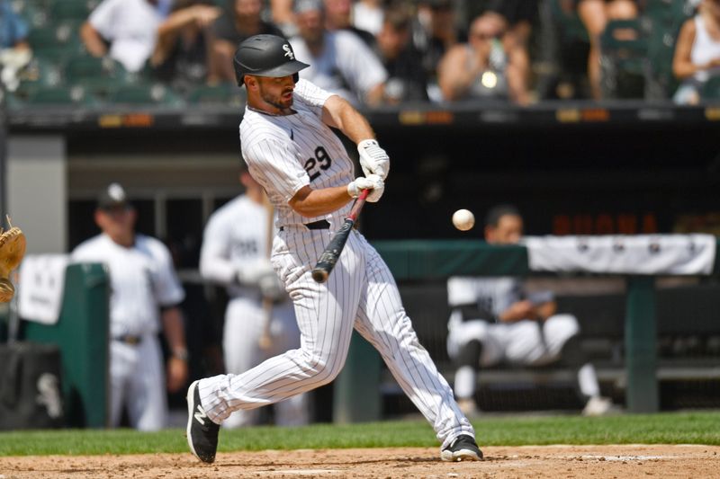 Jun 29, 2024; Chicago, Illinois, USA; Chicago White Sox shortstop Paul DeJong (29) hits a two-run home run during the sixth inning against the Colorado Rockies at Guaranteed Rate Field. Mandatory Credit: Patrick Gorski-USA TODAY Sports