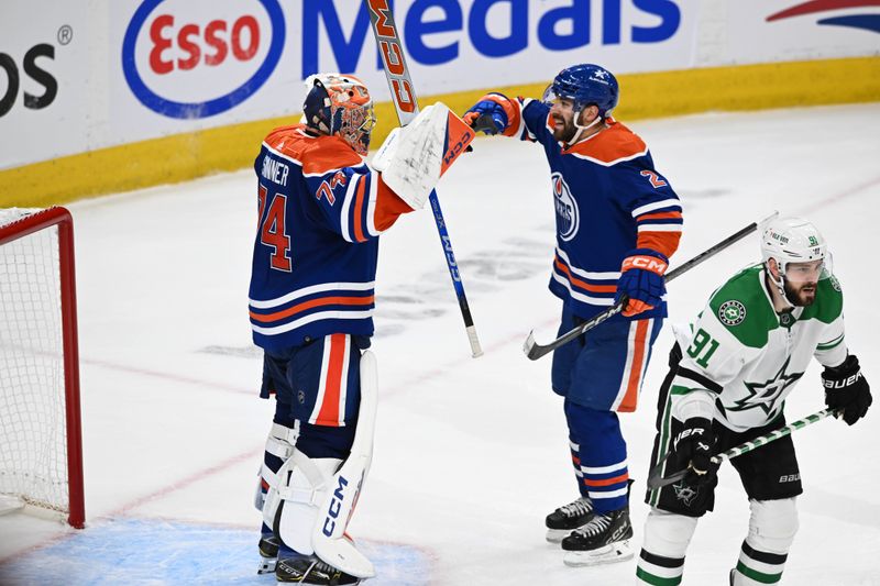 Jun 2, 2024; Edmonton, Alberta, CAN; Edmonton Oilers goalie Stuart Skinner (74) celebrate their win with Oilers defenceman Eric Bouchard (2) while Dallas Stars centre Tyler Seguin (91) skates away during the third period in game six of the Western Conference Final of the 2024 Stanley Cup Playoffs at Rogers Place. Mandatory Credit: Walter Tychnowicz-USA TODAY Sports