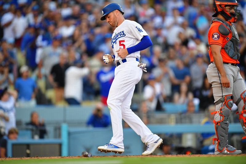 Jun 24, 2023; Los Angeles, California, USA;  Los Angeles Dodgers first baseman Freddie Freeman (5) scores a run against the Houston Astros during the eighth inning at Dodger Stadium. Mandatory Credit: Gary A. Vasquez-USA TODAY Sports