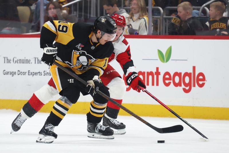 Dec 30, 2025; Pittsburgh, Pennsylvania, USA; Pittsburgh Penguins center Connor Dewar (19) moves the puck against Carolina Hurricanes right wing Jackson Blake (53) during the third period at PPG Paints Arena. Mandatory Credit: Charles LeClaire-Imagn Images