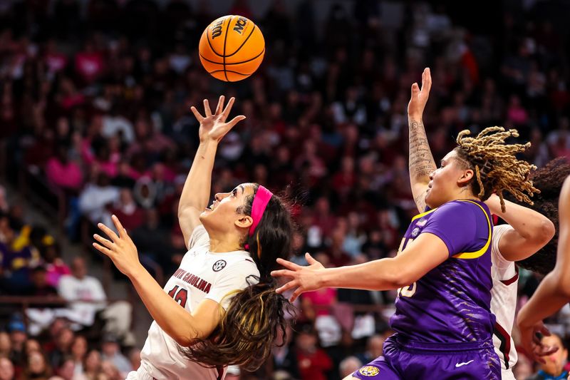 Feb 12, 2023; Columbia, South Carolina, USA; South Carolina Gamecocks center Kamilla Cardoso (10) grabs a rebound in front of LSU Lady Tigers guard Kateri Poole (55) in the first half at Colonial Life Arena. Mandatory Credit: Jeff Blake-USA TODAY Sports