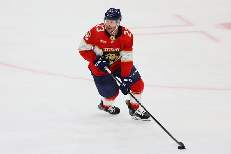 May 6, 2024; Sunrise, Florida, USA; Florida Panthers center Carter Verhaeghe (23) moves the puck against the Boston Bruins during the third period in game one of the second round of the 2024 Stanley Cup Playoffs at Amerant Bank Arena. Mandatory Credit: Sam Navarro-USA TODAY Sports